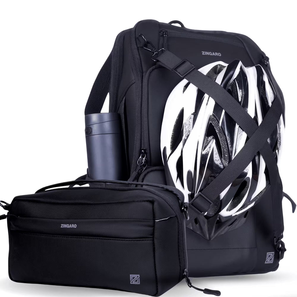 A black ZINGARO backpack shown with a matching black crossbody bag and a white-and-black bicycle helmet, photographed on a clean white background.
